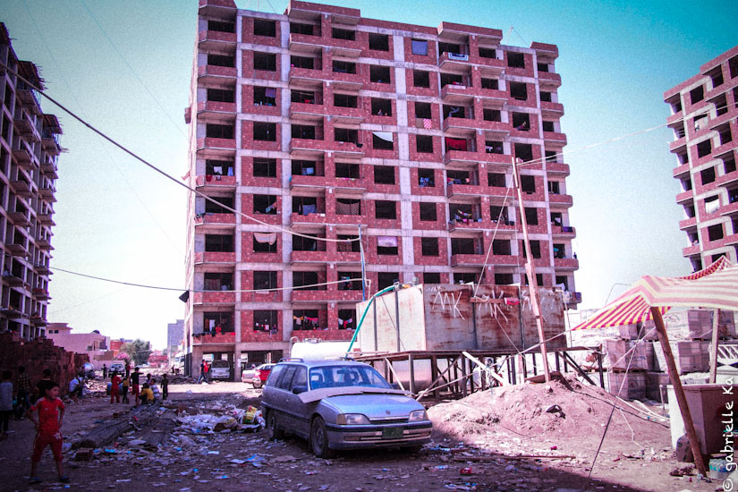 © Gabrielle Ka<br/><span>August, 2014. Dabin unfinished buildings in the early August hosting around 7000 IDP. NGO's like Doctors Without Borders responded with the installation of a mobile clinic giving free medical services.</span>